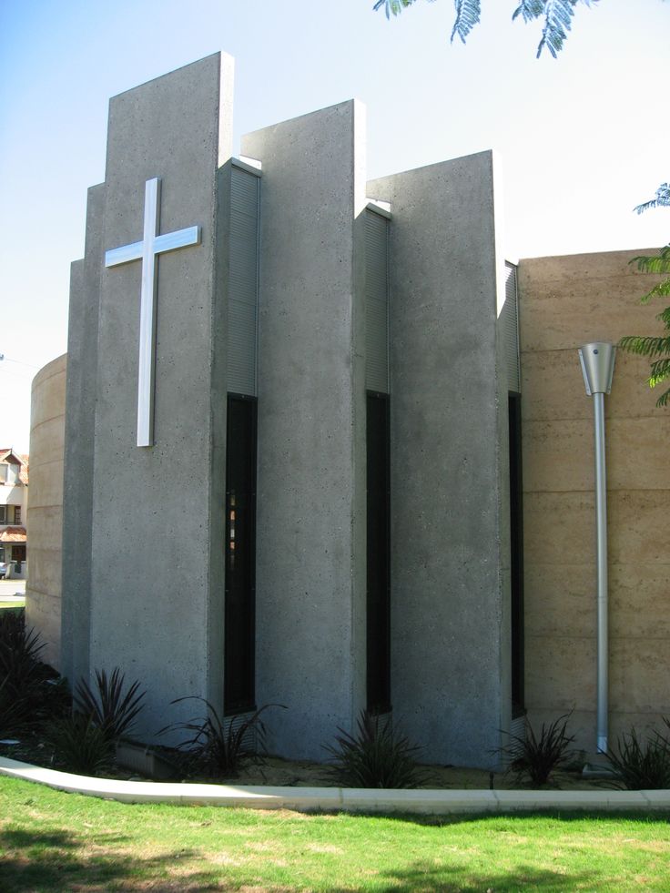 a church with two doors and a cross on the side