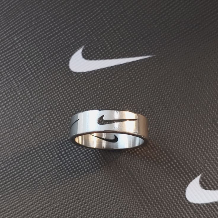 Price Firm! Bundle To Save! Brand New, Never Used Absolutely Stunning Unisex Ring Featuring Cut Out Iconic Nike Swoosh (4 Swoosh Cutouts/Ring) Medium Thickness Band Is Comfortable For Everyday Wear And Casual Enough For The Fashionable Athleisure Wear Outfit Made Of Titanium Steel For Optimal Wear Silver Tone Currently Available In Sizes 7 And 8 Cute Guy Gifts, Chunky Silver Rings Men, What To Get Guys For Christmas, Men Wishlist, Men’s Rings, Men’s Jewelry, Men Rings Aesthetic, Boy Rings, Fashionable Athleisure