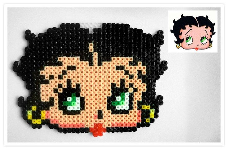 an image of a beaded brooch with anime character on it's face