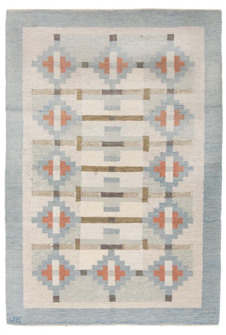 an old rug with geometric design on the front and back sides, in blue tones