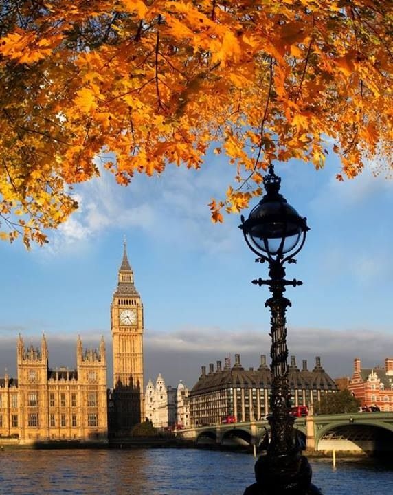 the big ben clock tower towering over the city of london, england in autumn time