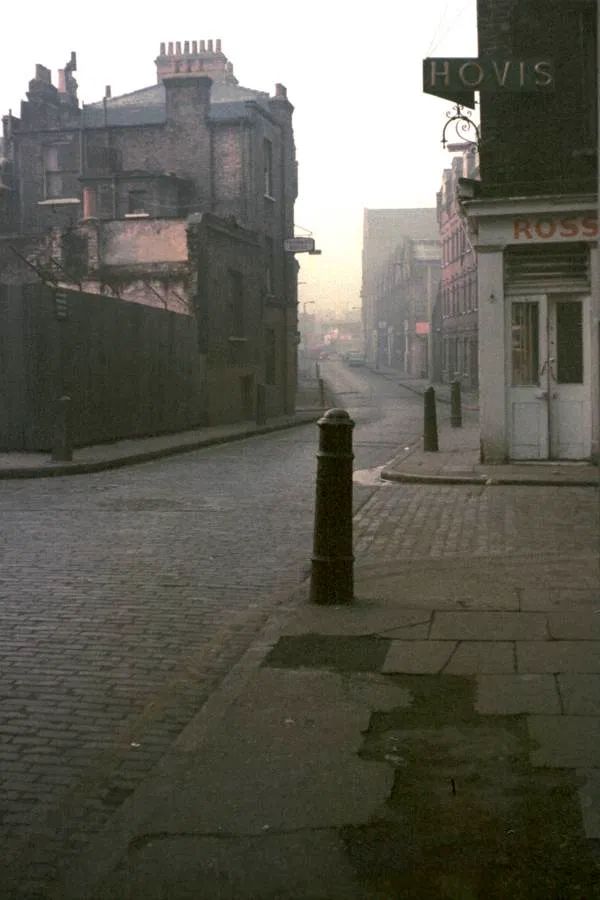 an empty city street with buildings on both sides