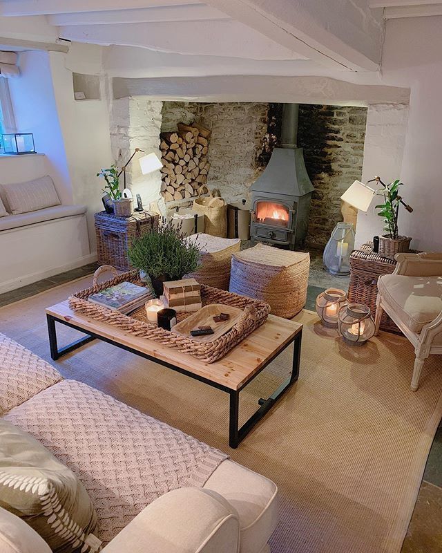 a living room filled with furniture and a fire place in the middle of the room