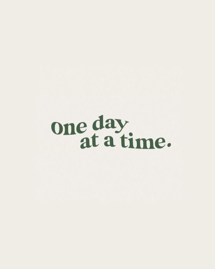 the words one day at a time are written in green ink on a white background