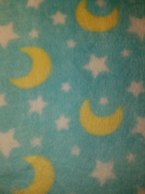 a blue and yellow blanket with stars and crescents on it