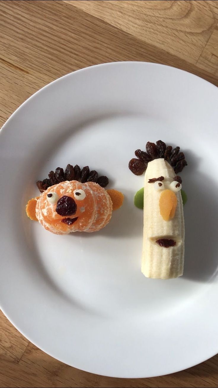 two fruit shaped like animals on a white plate