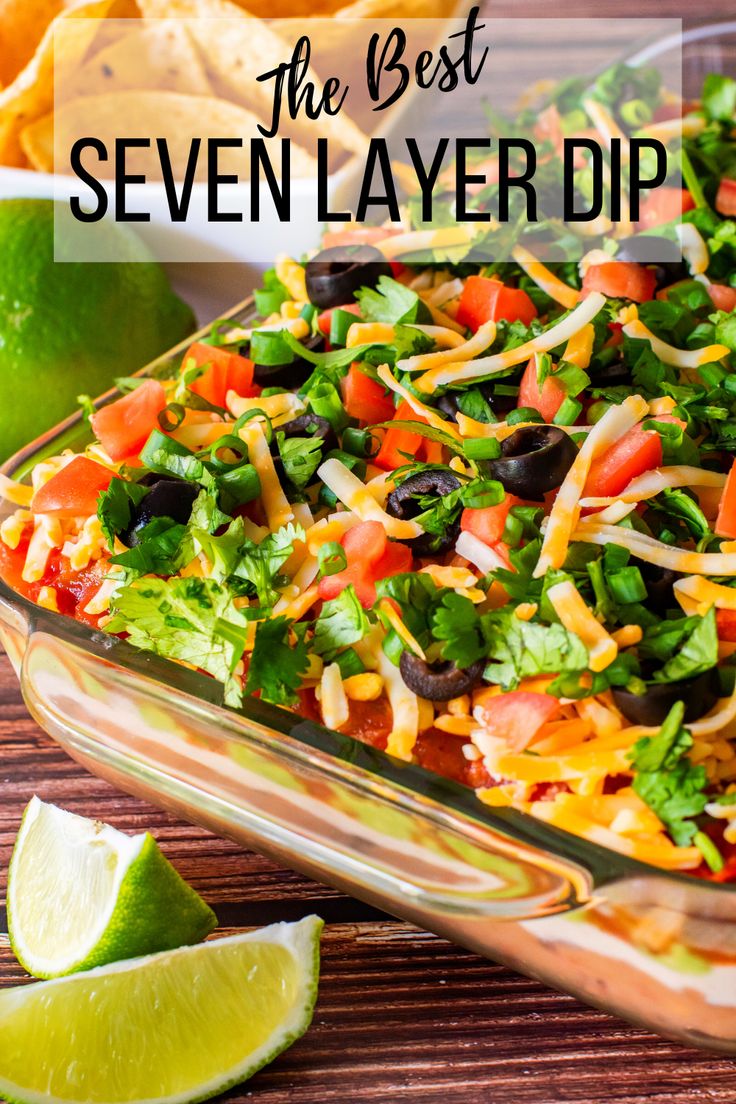 the best seven layer dip in a casserole dish with tortilla chips