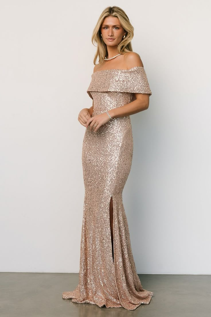 a woman in a gold sequin gown posing for the camera with her hands on her hips