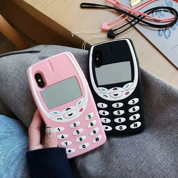 two pink and black cell phones sitting next to each other on a person's lap