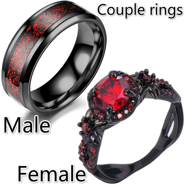 two rings with red and black stones on them, one is for male and the other is