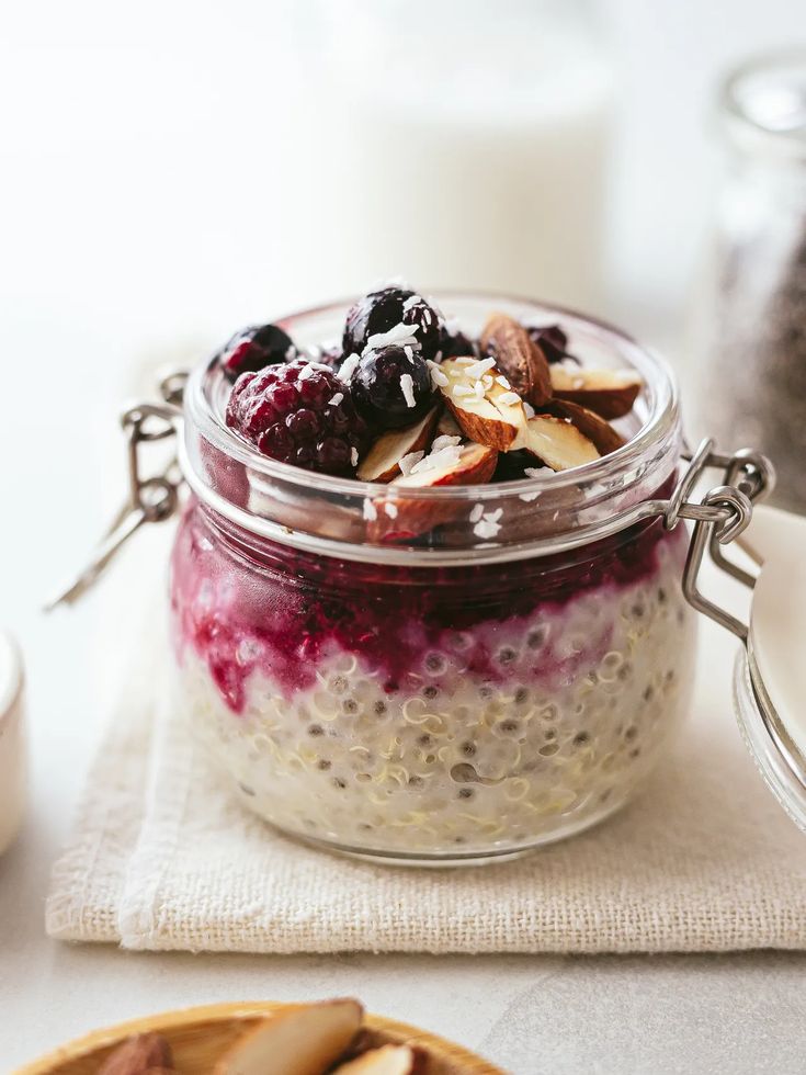 a glass jar filled with fruit and oatmeal sitting on top of a table