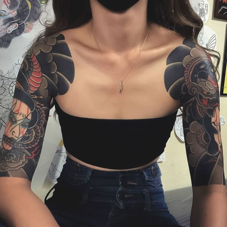 a woman with tattoos on her arms and chest