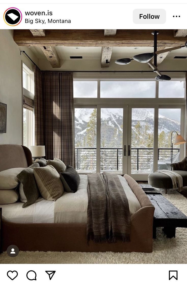 a bed room with a neatly made bed next to a window and a ceiling fan