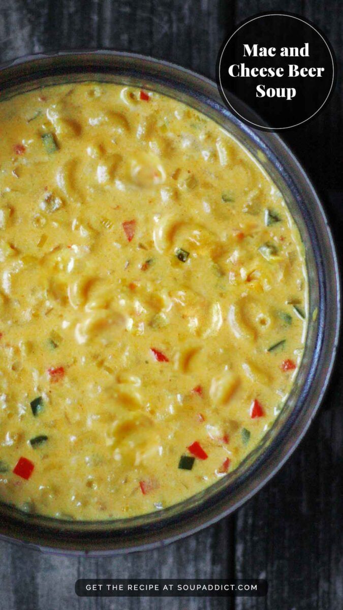 macaroni and cheese beer soup in a glass bowl on a wooden table with the title above it