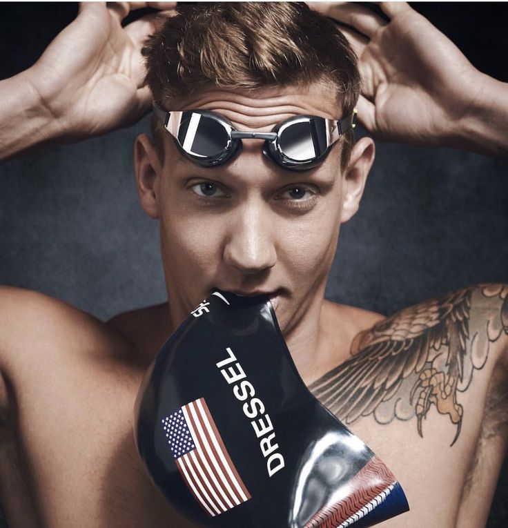 a man with goggles on his head and an american flag boxing glove in front of his face