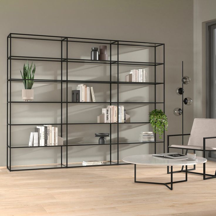 a living room filled with furniture and bookshelves next to a large glass window