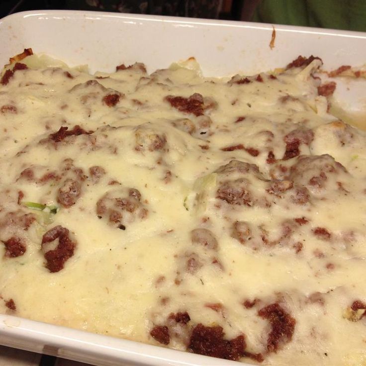 a casserole dish with meatballs and cheese in it