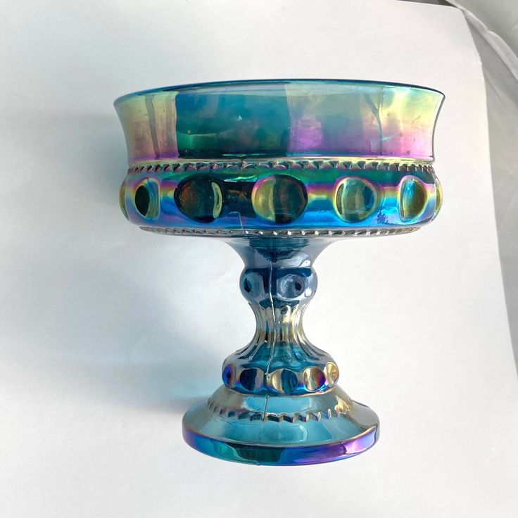 a colorful glass bowl sitting on top of a table