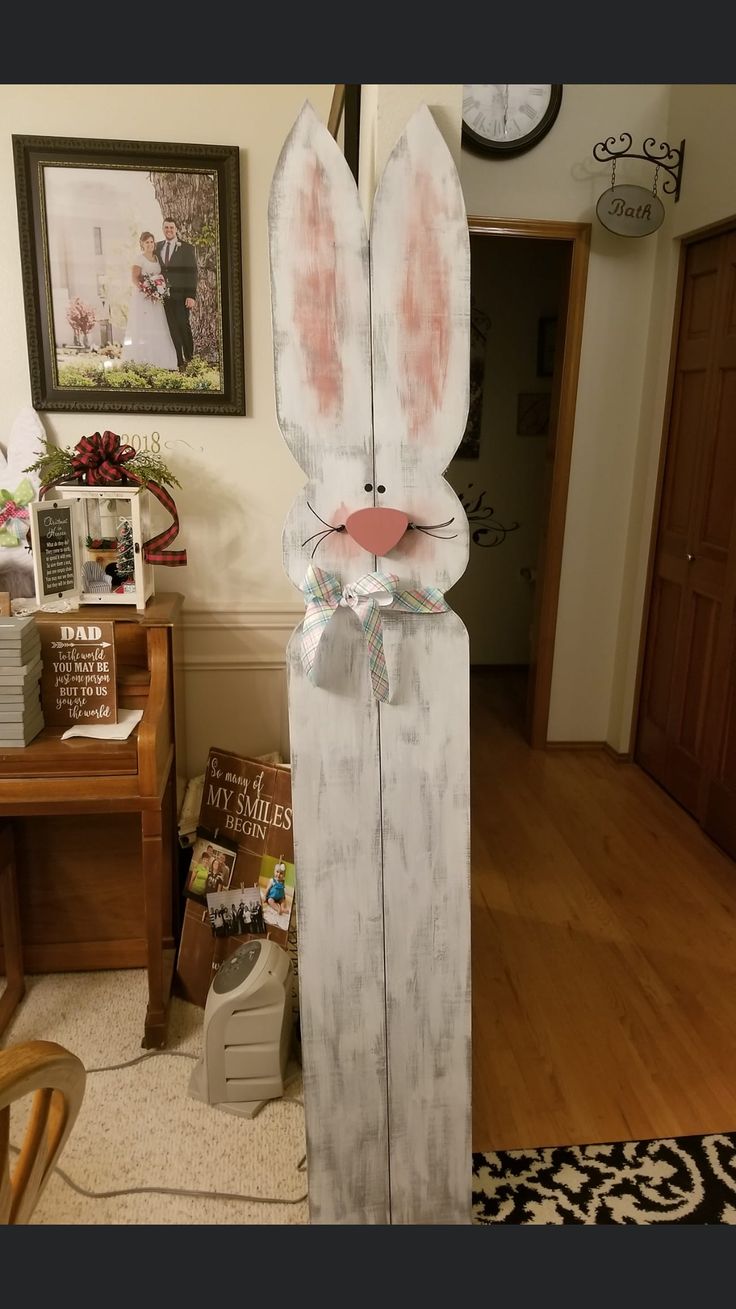 an easter bunny made out of wood in the middle of a living room