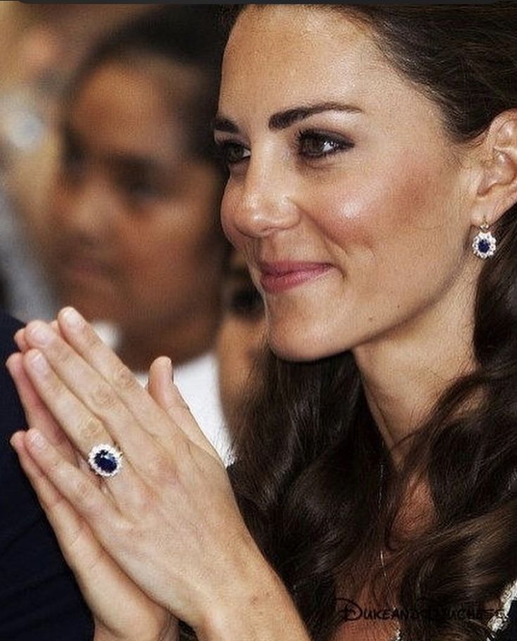 the duke and duchess of cambridge applauding with their hands together at an event