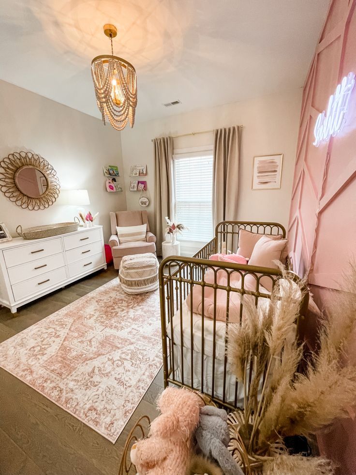 a baby's room is decorated in pink and white