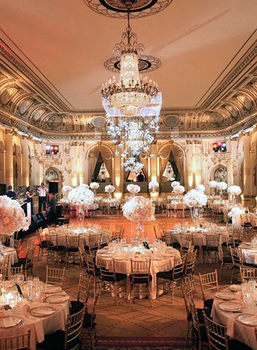 an elegant ballroom with chandeliers and tables