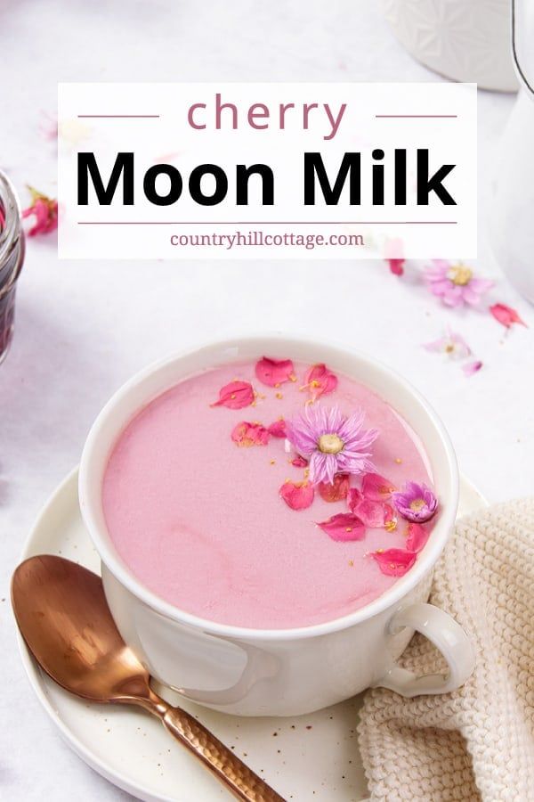 a cup of cherry moon milk with pink flowers