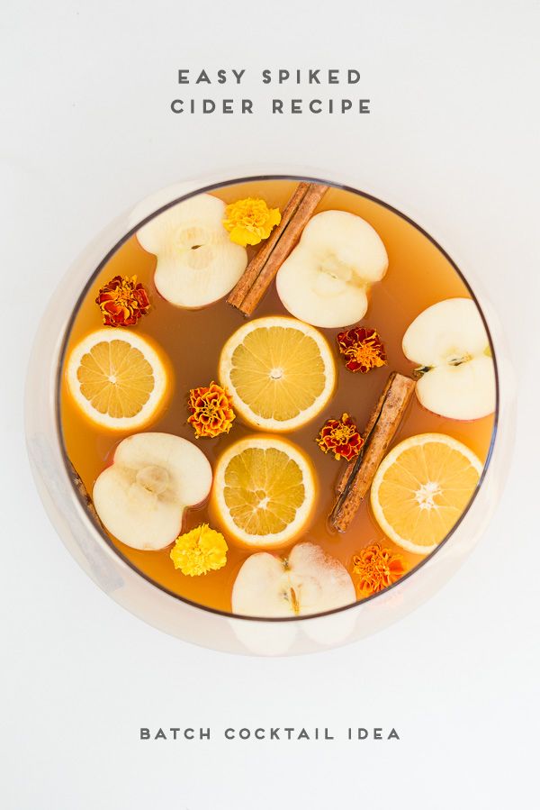 an overhead view of orange slices and cinnamons in a bowl