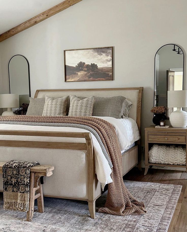 a bedroom with a bed, mirror and two stools