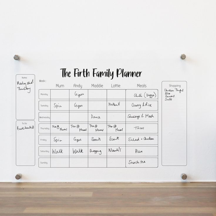 the first family planner wall decal is shown on a white wall with wood flooring