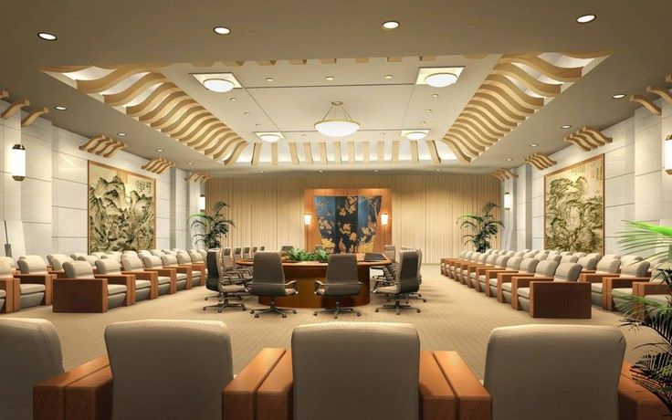 an empty conference room with white chairs and wood accents on the walls, along with plants