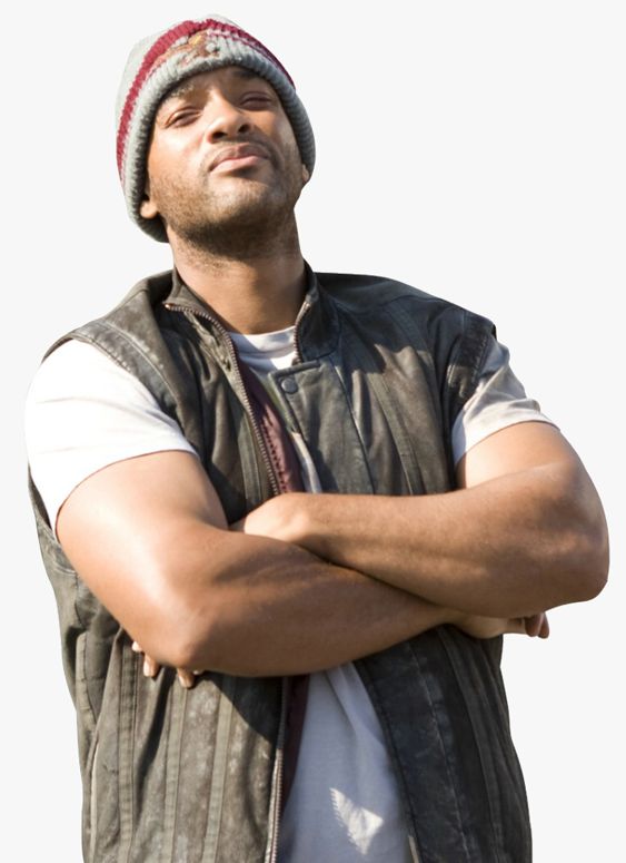 a man with his arms crossed standing in front of a white background wearing a hat and vest