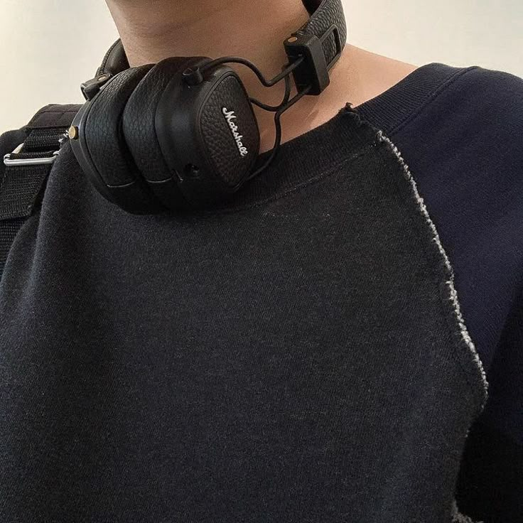 a man with headphones on his neck