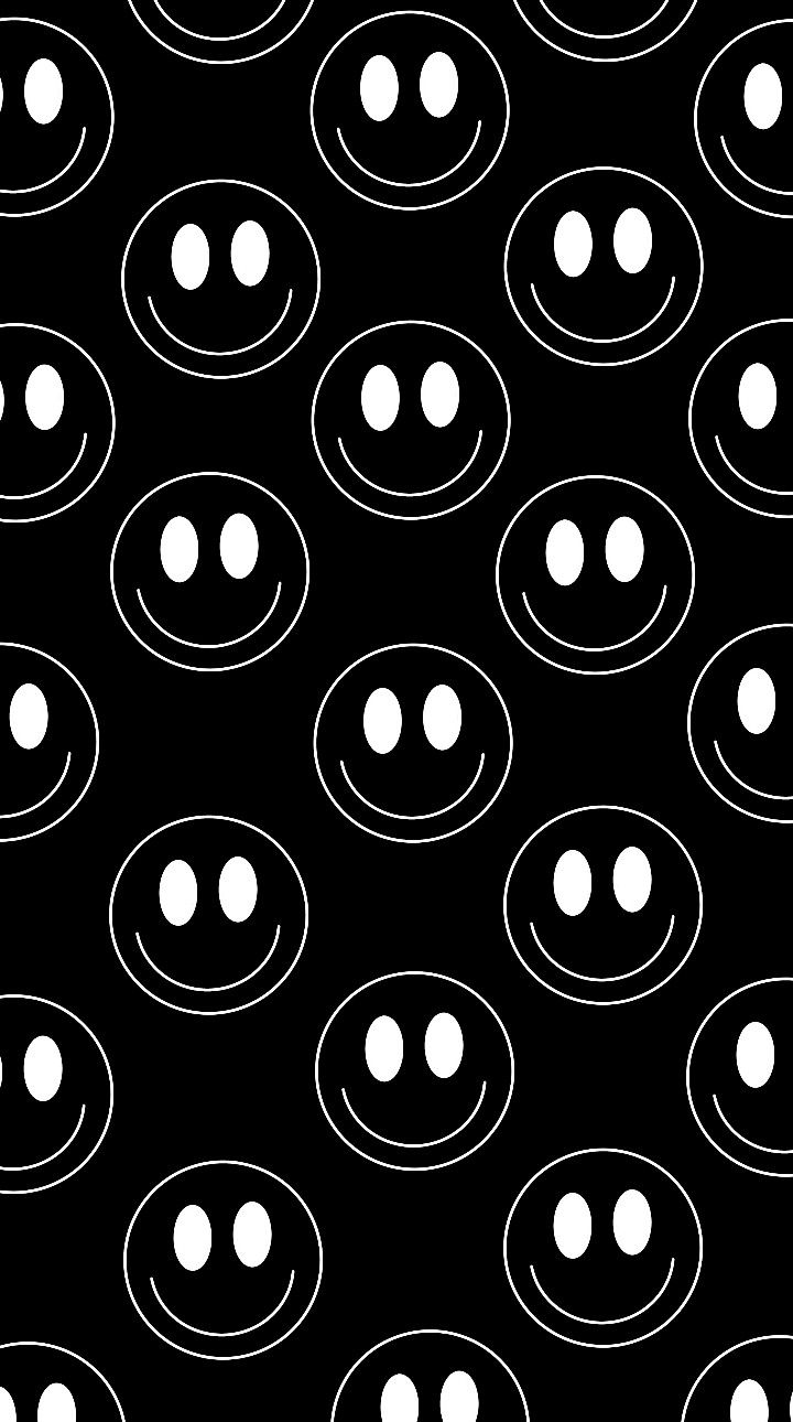 a black and white pattern with circles in the shape of smiley faces on a black background