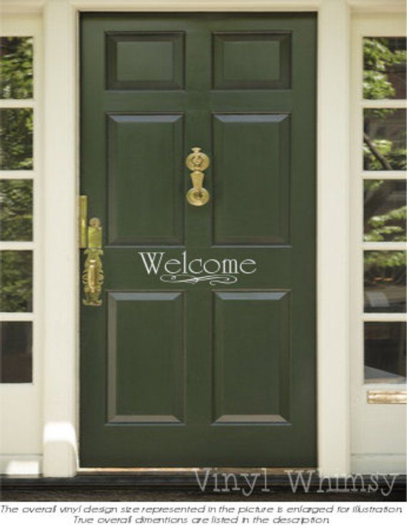 a green door with the words welcome written on it