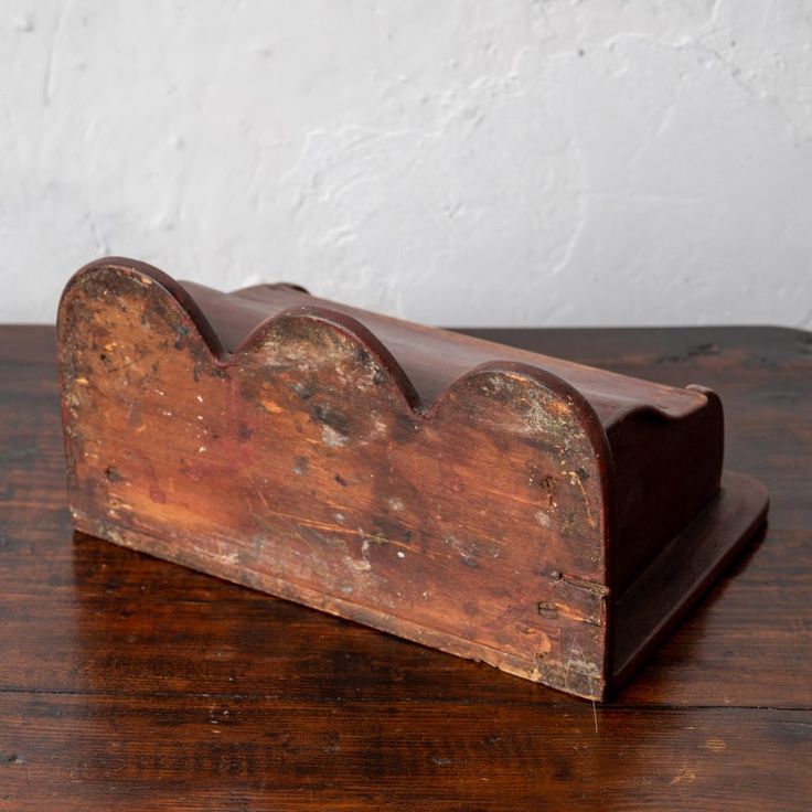 an old wooden object on a wood table