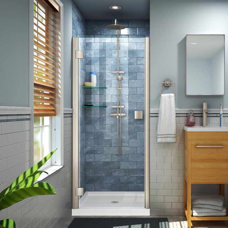 a bathroom with a walk in shower next to a sink