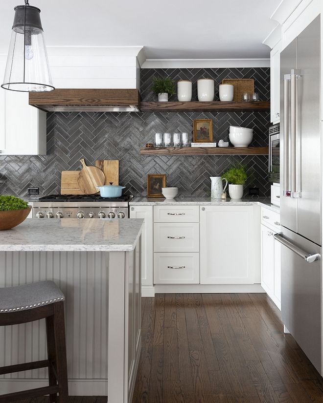 a kitchen with white cabinets and wooden shelves