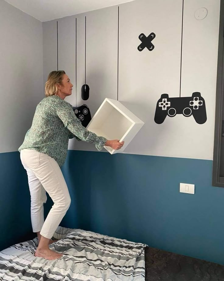 a woman standing on top of a bed holding a video game controller wall decal