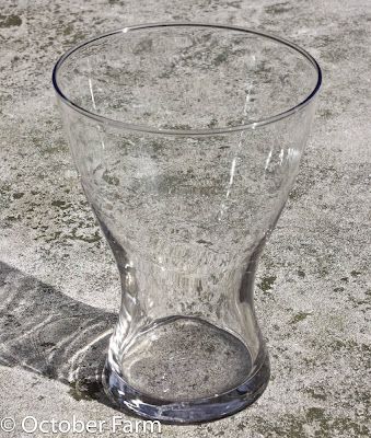 an empty glass sitting on the ground