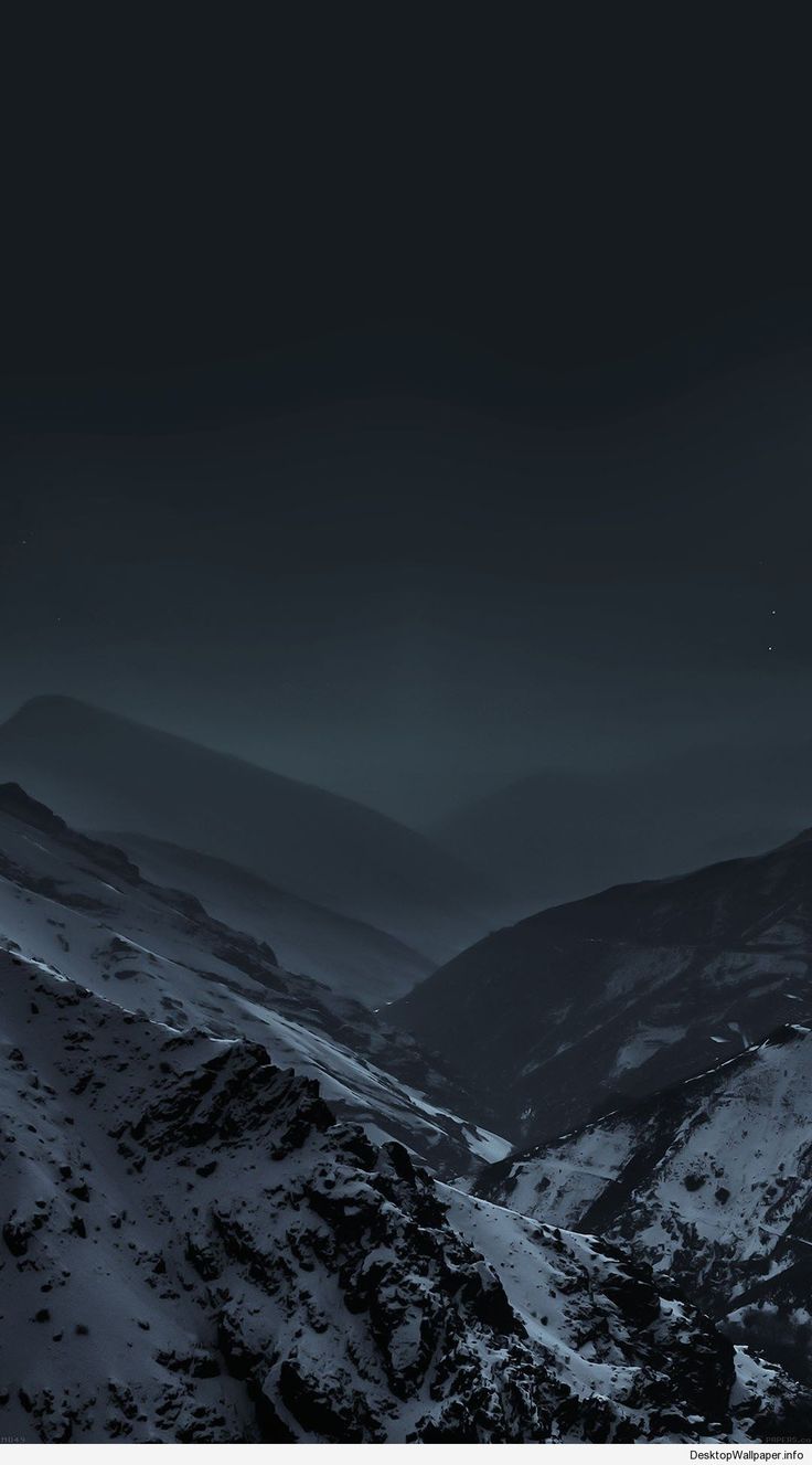 the mountains are covered in snow at night