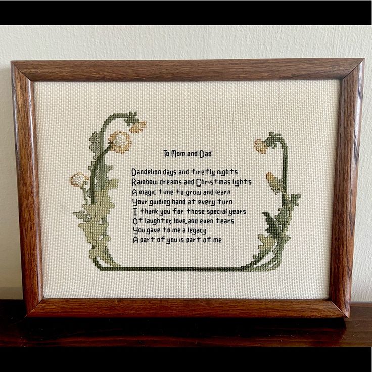 a framed cross stitch with a poem on it