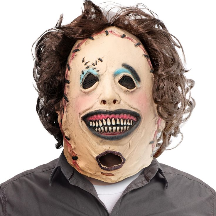 a man wearing a creepy mask with hair and makeup