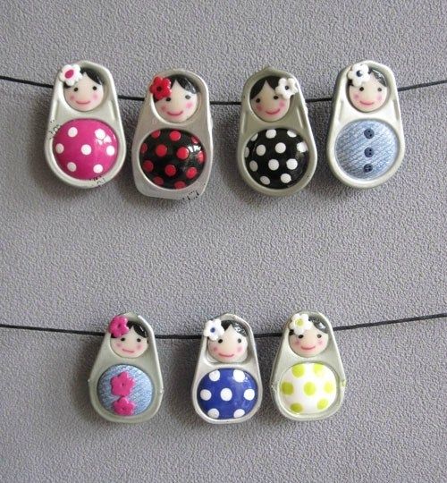 several magnets with ladybugs and polka dots on them hanging from a line