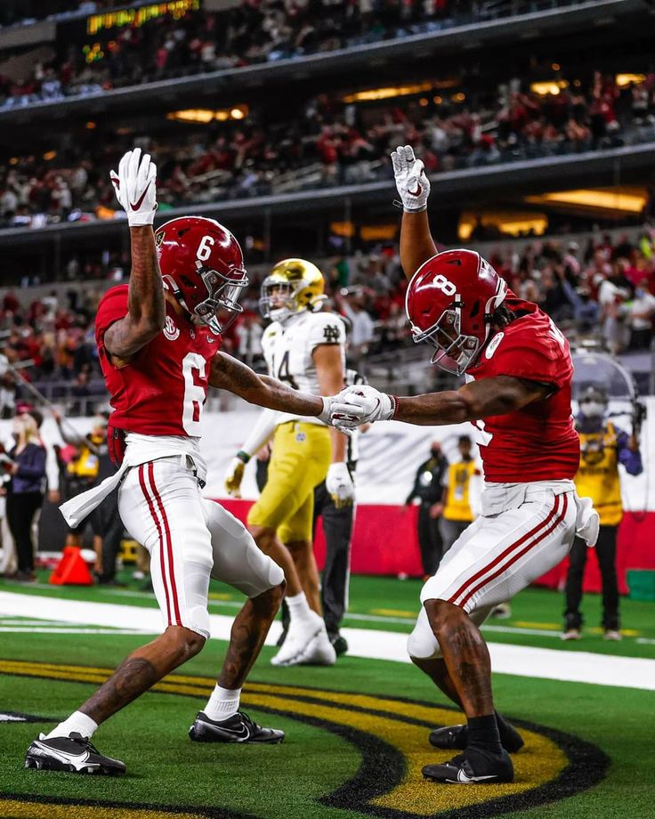 two football players are celebrating on the field