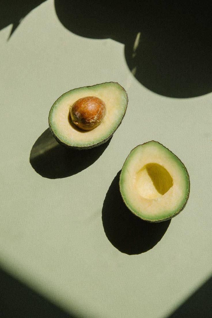 an avocado cut in half on a cutting board