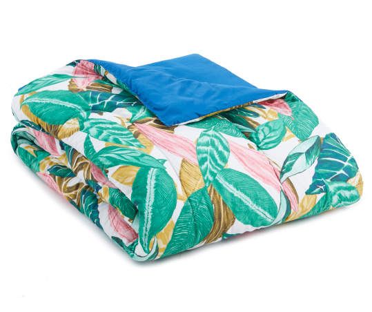 an image of a bed set with tropical print and blue comforter on white background