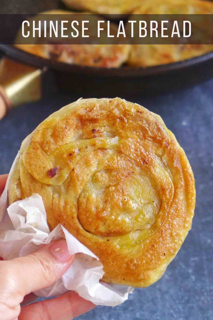 a person holding up a pastry with the words chinese flatbread in front of them