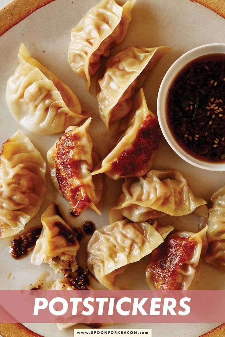 some dumplings are sitting on a plate with dipping sauce