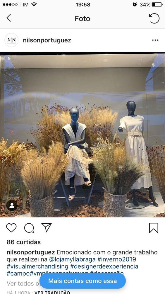 two mannequins are sitting in front of some plants